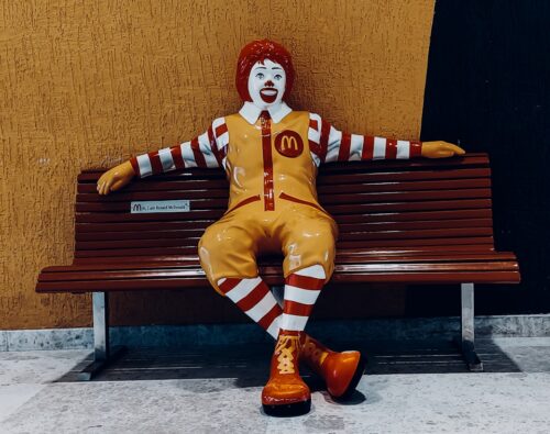 a clown sitting on a bench